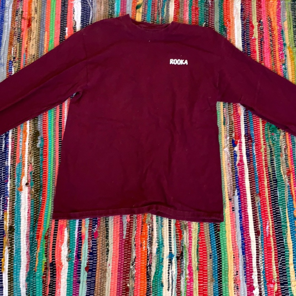 A maroon long sleeve shirt
